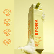 Flacon nettoyant pour le corps éclaircissant BYOMA avec marque et caractéristiques du produit sur fond jaune